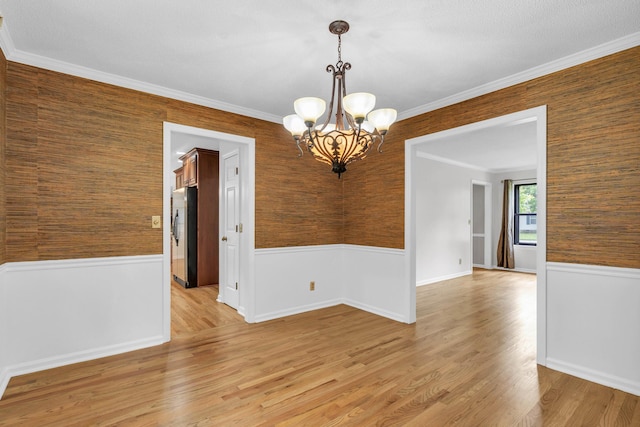 2434 Haven Cove Ln, Chattanooga, TN 37421 - empty room featuring a chandelier, a wainscoted wall, crown molding, light wood-style floors, and wooden walls