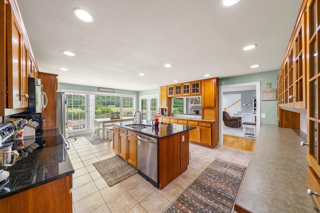 727 E Dumplin Valley Rd, Jefferson City, TN 37760 - kitchen with stainless steel appliances, a sink, a center island with sink, brown cabinetry, and glass insert cabinets