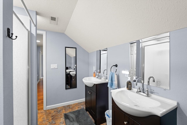 727 E Dumplin Valley Rd, Jefferson City, TN 37760 - full bath featuring two vanities, vaulted ceiling, baseboards, and a textured ceiling