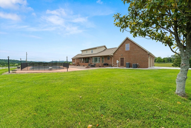 727 E Dumplin Valley Rd, Jefferson City, TN 37760 - rear view of property with brick siding, a patio, cooling unit, and a garage