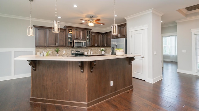 2062 Belleau Village Ln, Chattanooga, TN 37421 - kitchen with stainless steel appliances, dark brown cabinetry, light countertops, a breakfast bar area, and ornamental molding