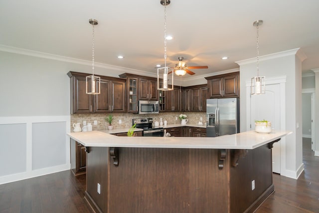 2062 Belleau Village Ln, Chattanooga, TN 37421 - kitchen with appliances with stainless steel finishes, crown molding, dark brown cabinetry, a ceiling fan, and backsplash
