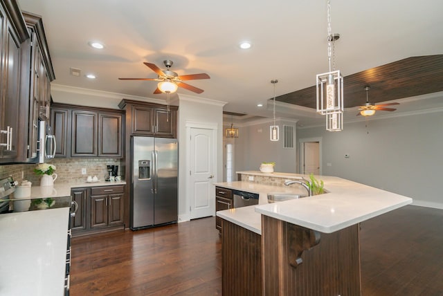 2062 Belleau Village Ln, Chattanooga, TN 37421 - kitchen featuring stainless steel appliances, a ceiling fan, crown molding, dark brown cabinetry, and light countertops