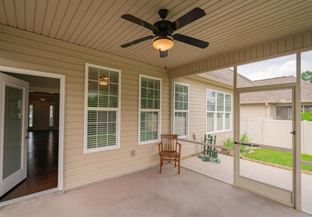 2062 Belleau Village Ln, Chattanooga, TN 37421 - sunroom with ceiling fan, wooden walls, and carpet floors