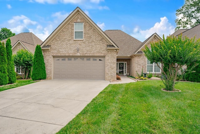 2062 Belleau Village Ln, Chattanooga, TN 37421 - traditional home featuring concrete driveway, a front yard, and brick siding