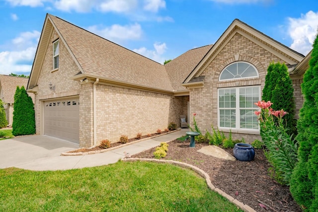 2062 Belleau Village Ln, Chattanooga, TN 37421 - view of front of property featuring a shingled roof, brick siding, driveway, and a garage
