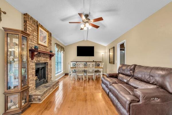 270 Rolling Meadows Dr, Ringgold, GA 30736 - living area featuring a ceiling fan, a brick fireplace, vaulted ceiling, light wood finished floors, and baseboards