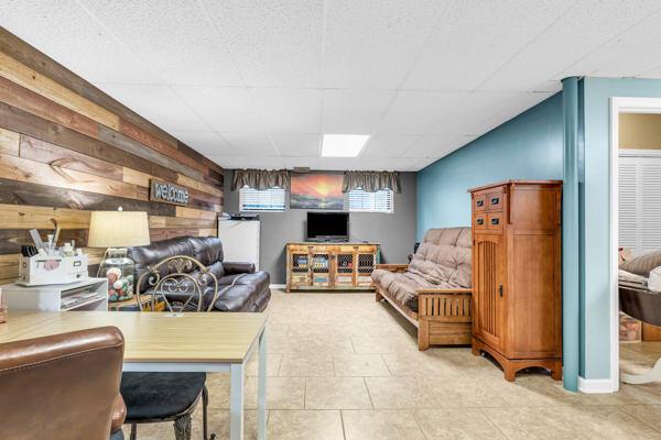 270 Rolling Meadows Dr, Ringgold, GA 30736 - tiled living room featuring wood walls