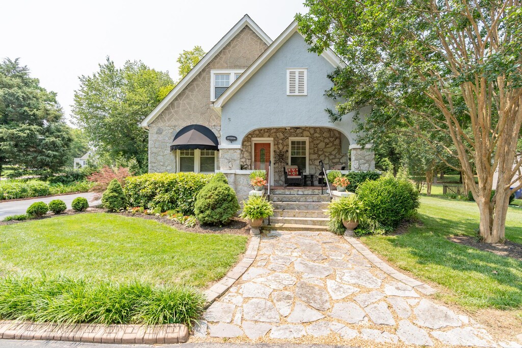 232 Bass Rd, Chattanooga, TN 37421 - view of front of home with stone siding, covered porch, a front yard, and stucco siding