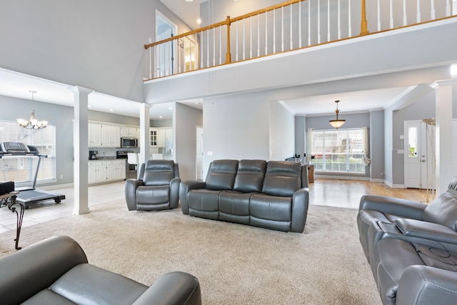 8021 Hamilton Mill Dr, Chattanooga, TN 37421 - living area with decorative columns, light carpet, baseboards, a high ceiling, and a chandelier