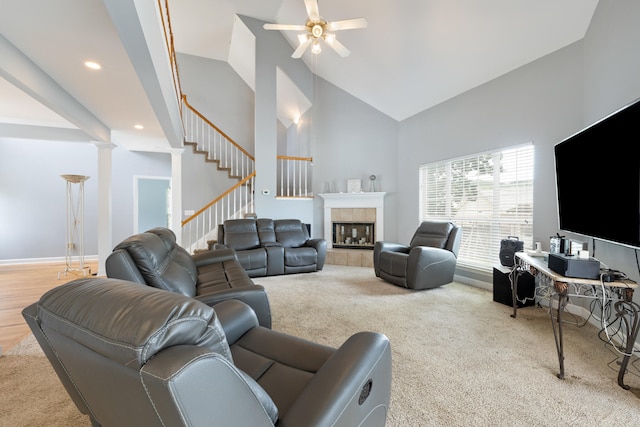 8021 Hamilton Mill Dr, Chattanooga, TN 37421 - carpeted living area with high vaulted ceiling, ceiling fan, a tiled fireplace, stairs, and recessed lighting