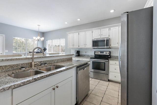 8021 Hamilton Mill Dr, Chattanooga, TN 37421 - kitchen with appliances with stainless steel finishes, a sink, white cabinets, a chandelier, and light tile patterned floors