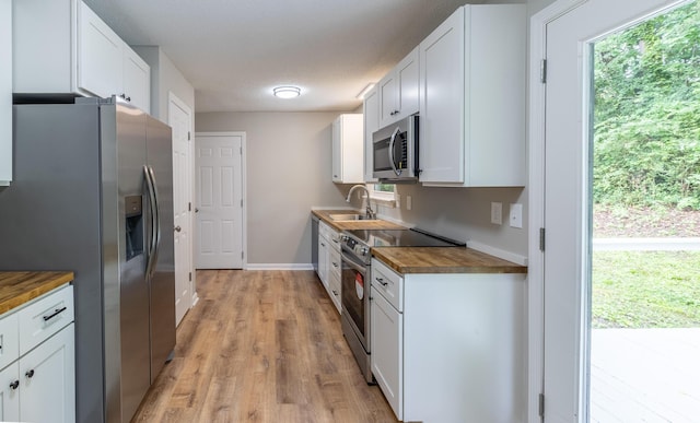 8539 Ricardo Ln, Hixson, TN 37343 - kitchen with stainless steel appliances, wood counters, a sink, and white cabinets