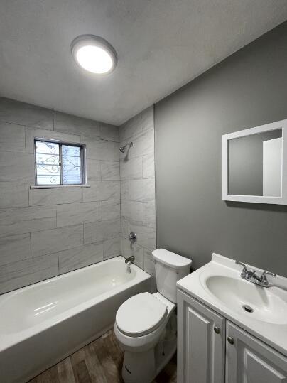 full bathroom featuring vanity, wood finished floors, and shower / bath combination