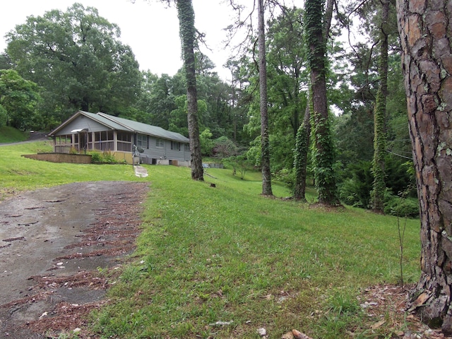 895 W Schmitt Rd, Rossville, GA 30741 - view of front of property with driveway, a front yard, a sunroom, and a wooded view