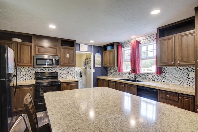 452 Davenport Rd, Resaca, GA 30735 - kitchen with open shelves, black appliances, washer and dryer, a sink, and a textured ceiling
