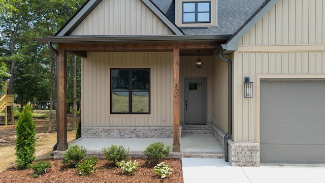 300 Dogwood Ln, Fort Oglethorpe, GA 30742 - entrance to property with a garage, a porch, a shingled roof, and board and batten siding