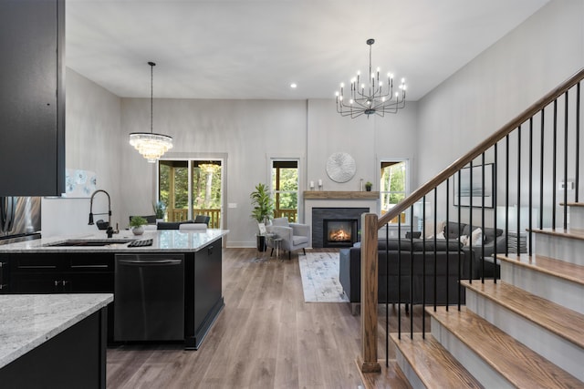 300 Dogwood Ln, Fort Oglethorpe, GA 30742 - kitchen featuring dark cabinets, a chandelier, dishwasher, light wood-type flooring, and recessed lighting