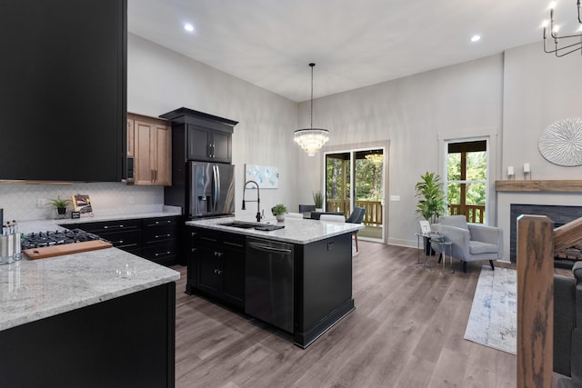 300 Dogwood Ln, Fort Oglethorpe, GA 30742 - kitchen featuring a chandelier, appliances with stainless steel finishes, a towering ceiling, dark cabinets, and hanging light fixtures