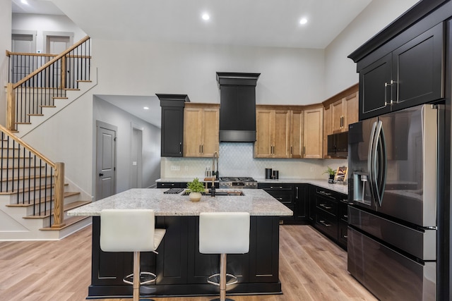 300 Dogwood Ln, Fort Oglethorpe, GA 30742 - kitchen featuring stainless steel fridge with ice dispenser, light wood-style floors, light stone countertops, decorative backsplash, and recessed lighting