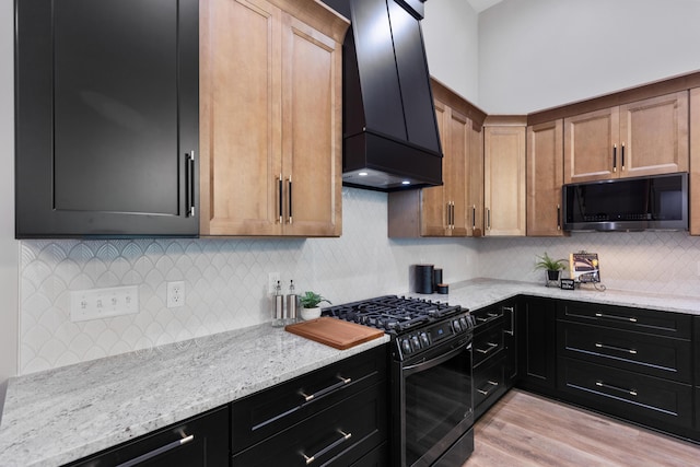 300 Dogwood Ln, Fort Oglethorpe, GA 30742 - kitchen with range with gas cooktop, custom exhaust hood, black microwave, and light stone countertops