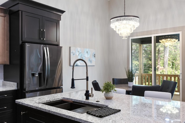 300 Dogwood Ln, Fort Oglethorpe, GA 30742 - kitchen with stainless steel refrigerator with ice dispenser, light stone countertops, and a chandelier