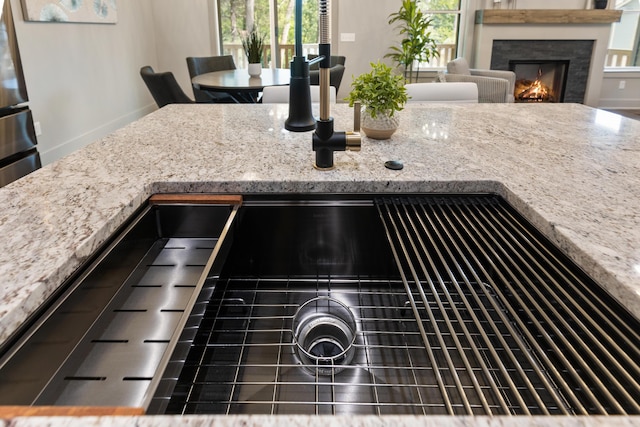 300 Dogwood Ln, Fort Oglethorpe, GA 30742 - kitchen view of light stone countertops and a warm lit fireplace