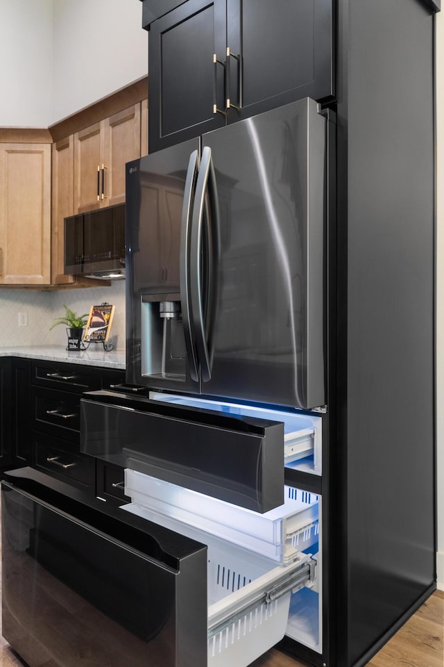300 Dogwood Ln, Fort Oglethorpe, GA 30742 - kitchen with stainless steel refrigerator with ice dispenser, black microwave, light wood-style floors, and light stone counters