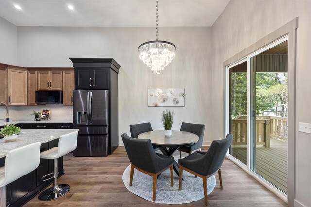 300 Dogwood Ln, Fort Oglethorpe, GA 30742 - dining room with a chandelier, dark wood finished floors, recessed lighting, and a towering ceiling