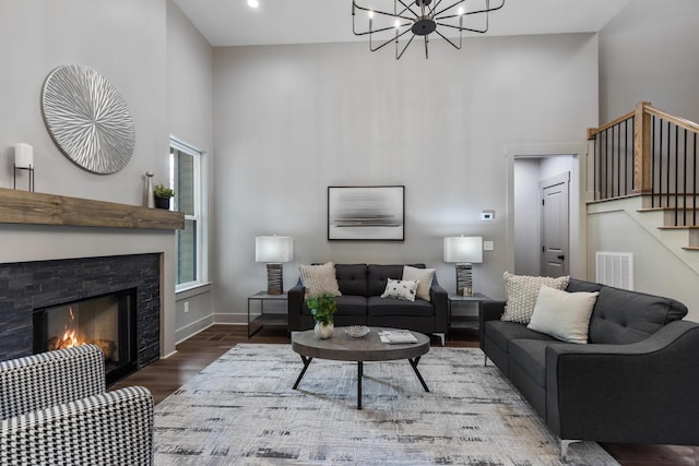 300 Dogwood Ln, Fort Oglethorpe, GA 30742 - living area with a high ceiling, wood finished floors, stairway, a tiled fireplace, and a chandelier