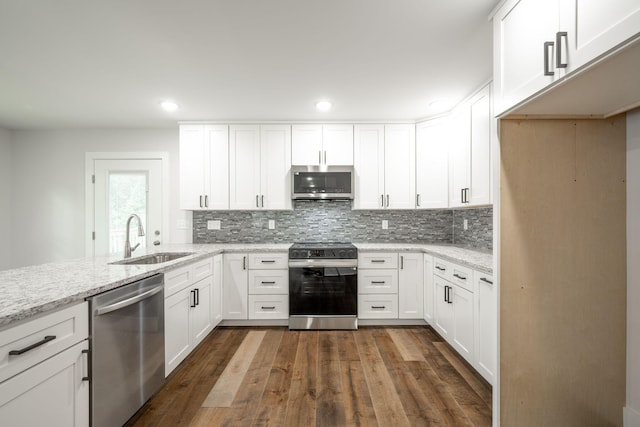 3914 Bennett Rd, Chattanooga, TN 37412 - kitchen with appliances with stainless steel finishes, a sink, white cabinets, and recessed lighting