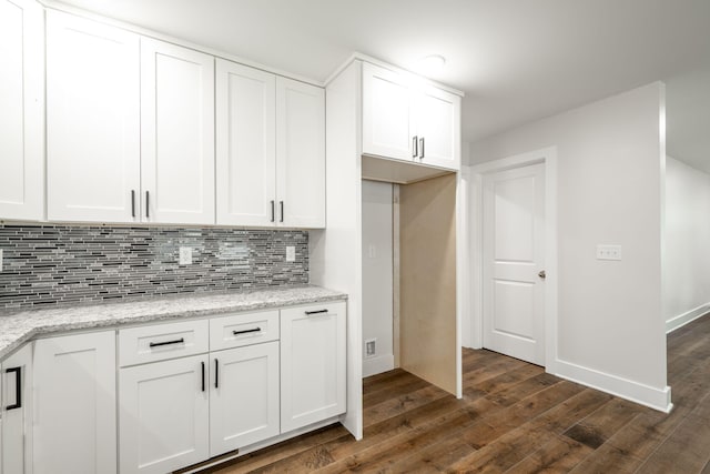 3914 Bennett Rd, Chattanooga, TN 37412 - kitchen featuring backsplash, dark wood-type flooring, white cabinetry, and light stone counters