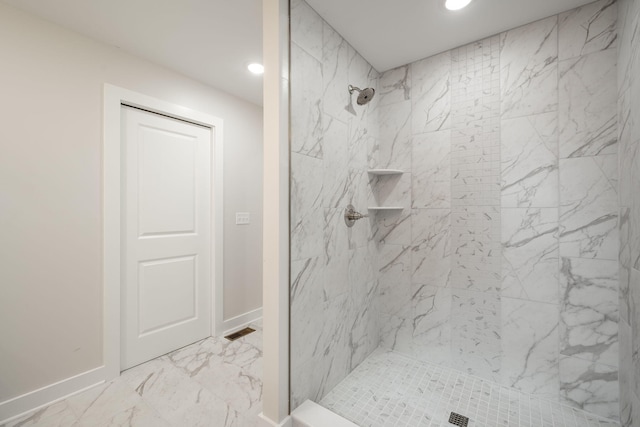3914 Bennett Rd, Chattanooga, TN 37412 - bathroom featuring a tile shower, recessed lighting, marble look tiles, and baseboards