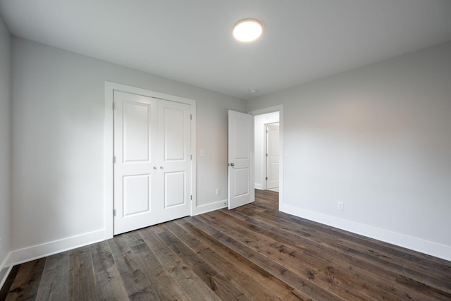 3914 Bennett Rd, Chattanooga, TN 37412 - unfurnished bedroom with baseboards, dark wood-style floors, and a closet