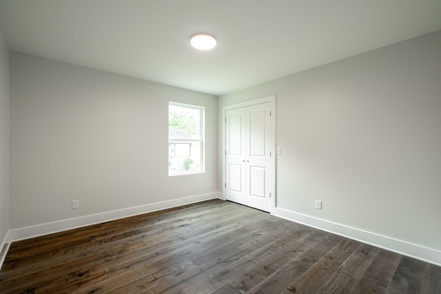 3914 Bennett Rd, Chattanooga, TN 37412 - unfurnished bedroom with baseboards, dark wood-type flooring, and a closet