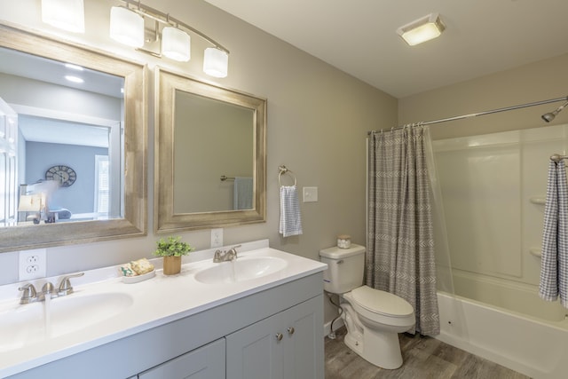 4907 Mccallie Ave, Apison, TN 37302 - bathroom featuring wood finished floors, double vanity, and shower / bath combo with shower curtain