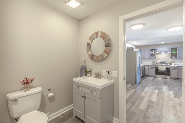 4907 Mccallie Ave, Apison, TN 37302 - bathroom featuring vanity, wood finished floors, and backsplash