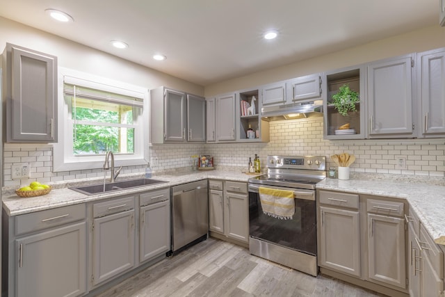 4907 Mccallie Ave, Apison, TN 37302 - kitchen with stainless steel appliances, open shelves, under cabinet range hood, gray cabinets, and tasteful backsplash