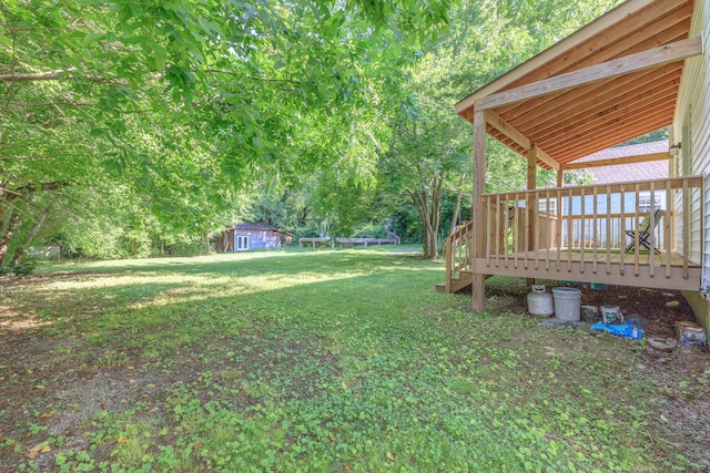 4907 Mccallie Ave, Apison, TN 37302 - view of grassy yard featuring a wooden deck, a trampoline, and an outbuilding