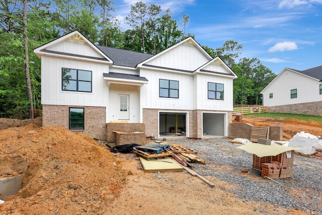 10907 Dolly Pond Rd, Ooltewah, TN 37363 - view of front of home featuring board and batten siding, a shingled roof, and brick siding