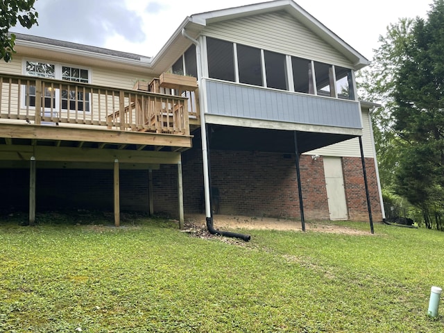 610 Hickory Ridge Trl, Ringgold, GA 30736 - back of property featuring a lawn, a wooden deck, a sunroom, and brick siding