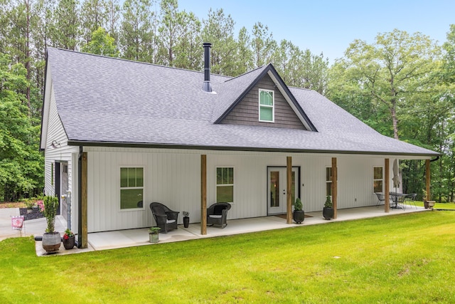 8331 Troubadour Way, Ooltewah, TN 37363 - rear view of house with a shingled roof, a lawn, and a patio