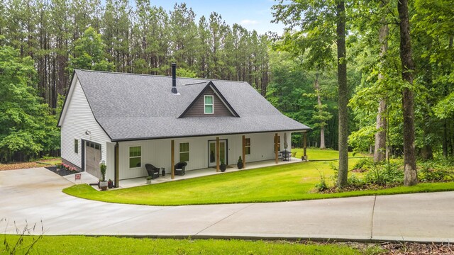 8331 Troubadour Way, Ooltewah, TN 37363 - view of front of house with a porch, roof with shingles, a front yard, and concrete driveway