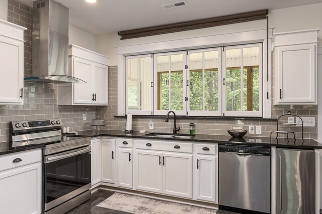 8331 Troubadour Way, Ooltewah, TN 37363 - kitchen with appliances with stainless steel finishes, wall chimney exhaust hood, decorative backsplash, and dark countertops