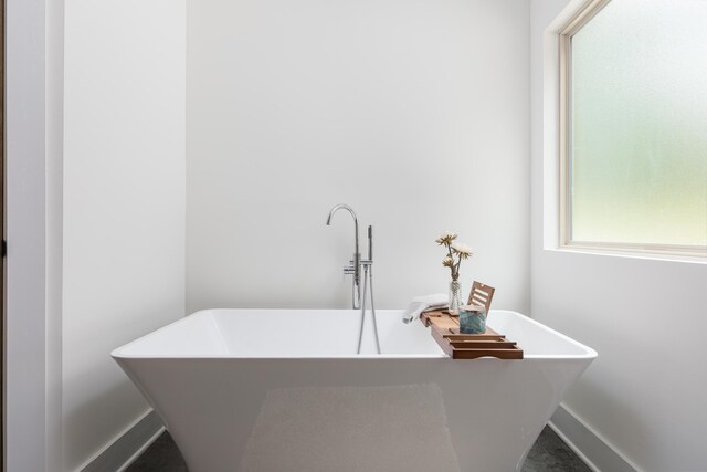 8331 Troubadour Way, Ooltewah, TN 37363 - full bathroom featuring a soaking tub, a sink, and baseboards