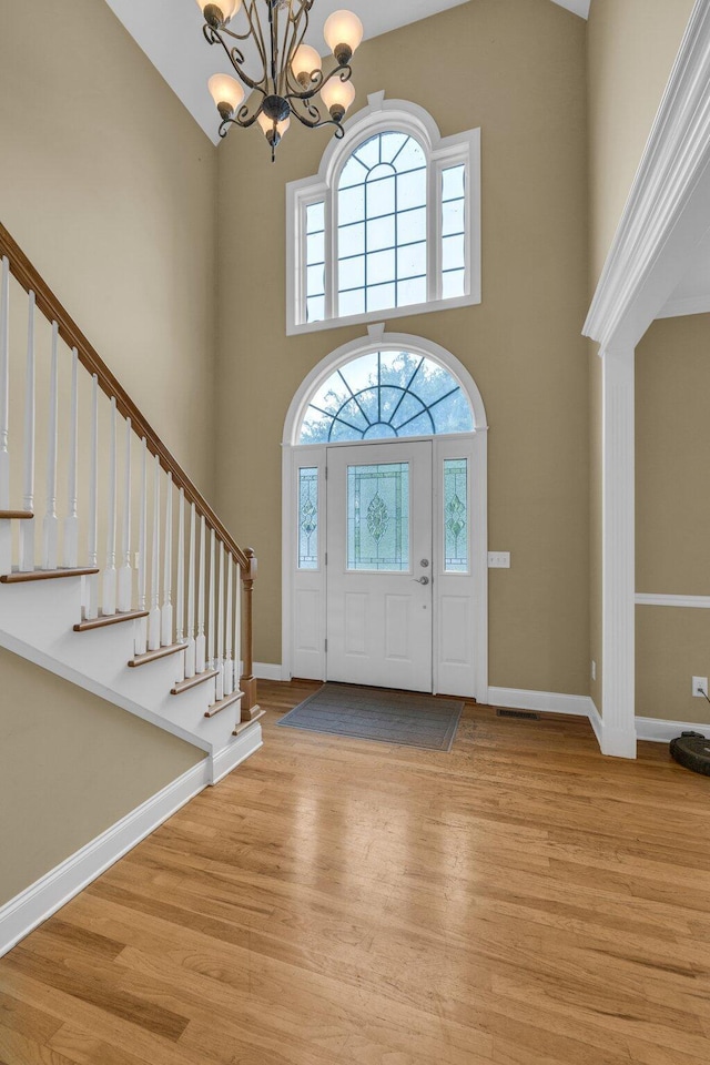 57 Clear Springs Dr, Ringgold, GA 30736 - foyer entrance with a high ceiling, a chandelier, light wood-style flooring, plenty of natural light, and stairway