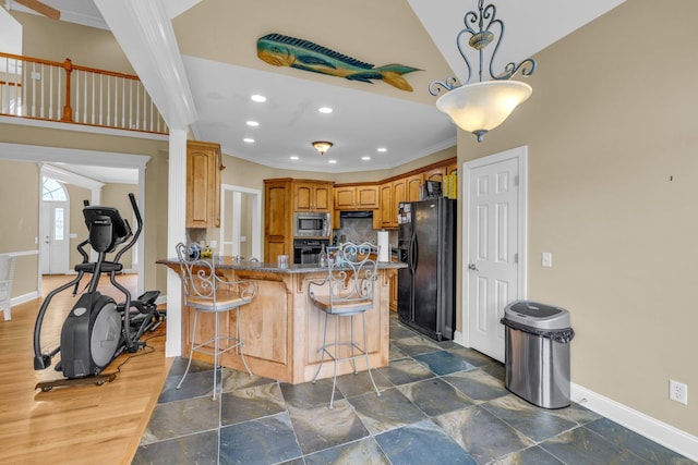 57 Clear Springs Dr, Ringgold, GA 30736 - kitchen featuring black appliances, baseboards, a kitchen bar, stone counters, and a peninsula