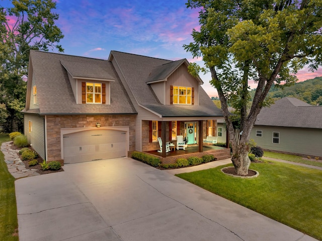 3429 Willow Lake Cir, Chattanooga, TN 37419 - view of front of property with covered porch, concrete driveway, stone siding, a front lawn, and an attached garage