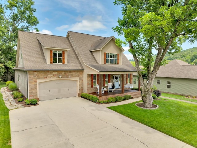 3429 Willow Lake Cir, Chattanooga, TN 37419 - view of front of house featuring a porch, stone siding, driveway, a front lawn, and an attached garage