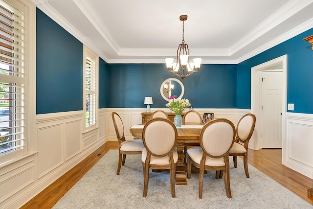 3429 Willow Lake Cir, Chattanooga, TN 37419 - dining room featuring a chandelier, wood finished floors, a wainscoted wall, a decorative wall, and crown molding